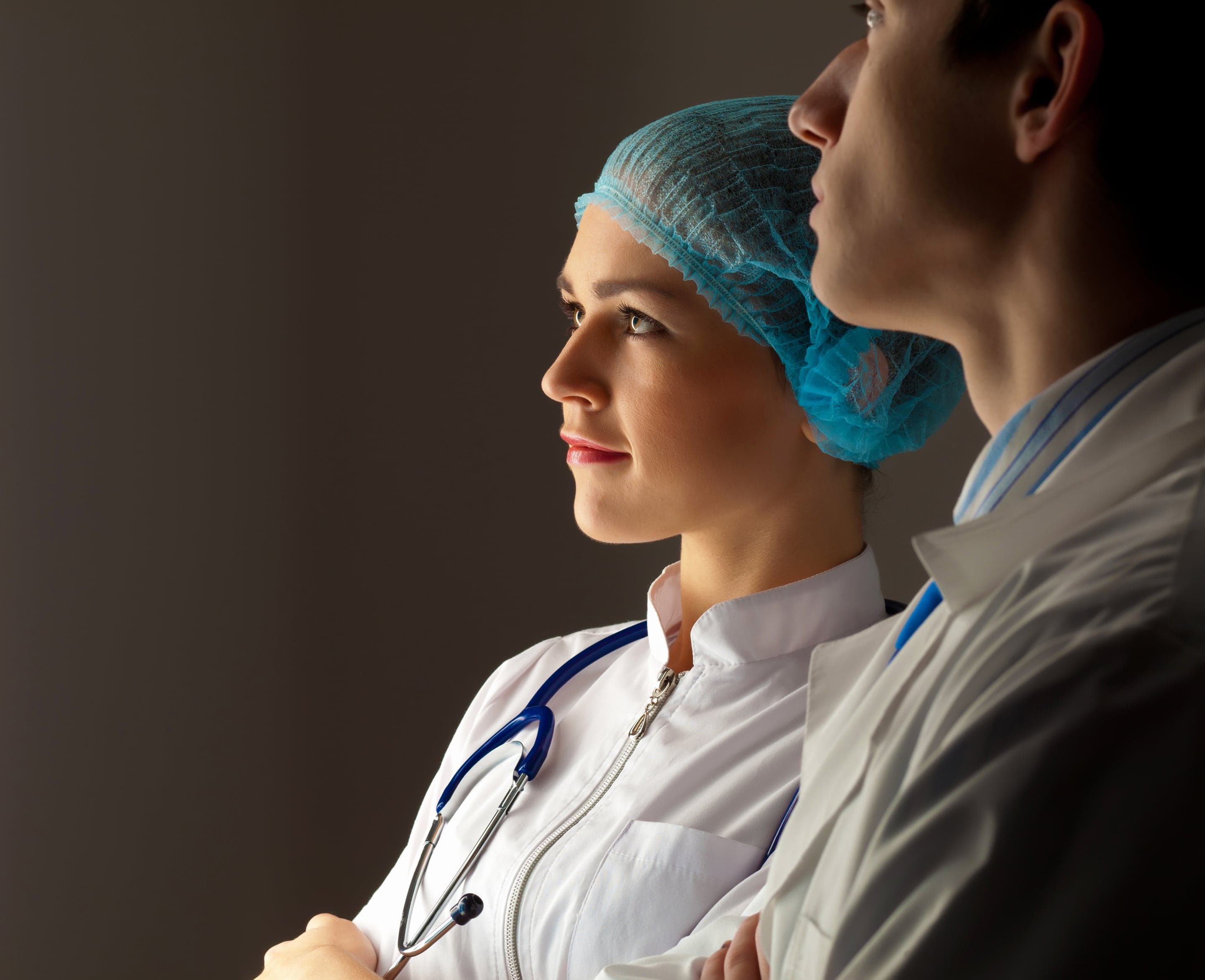 Two clinicians reading operations dashboards together in a clinic reading room