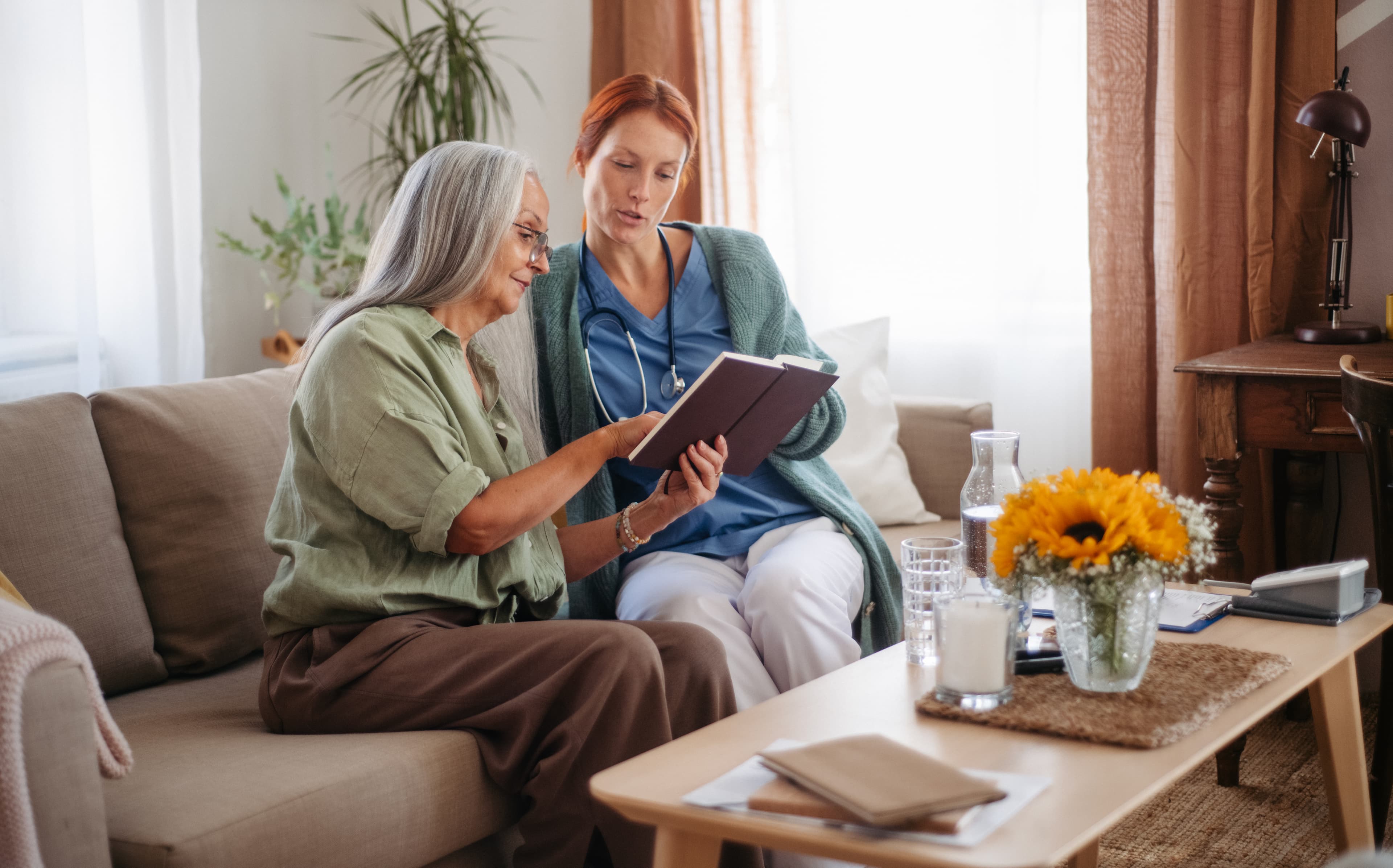 A patient at home going through a virtual care plan with family in a bright room